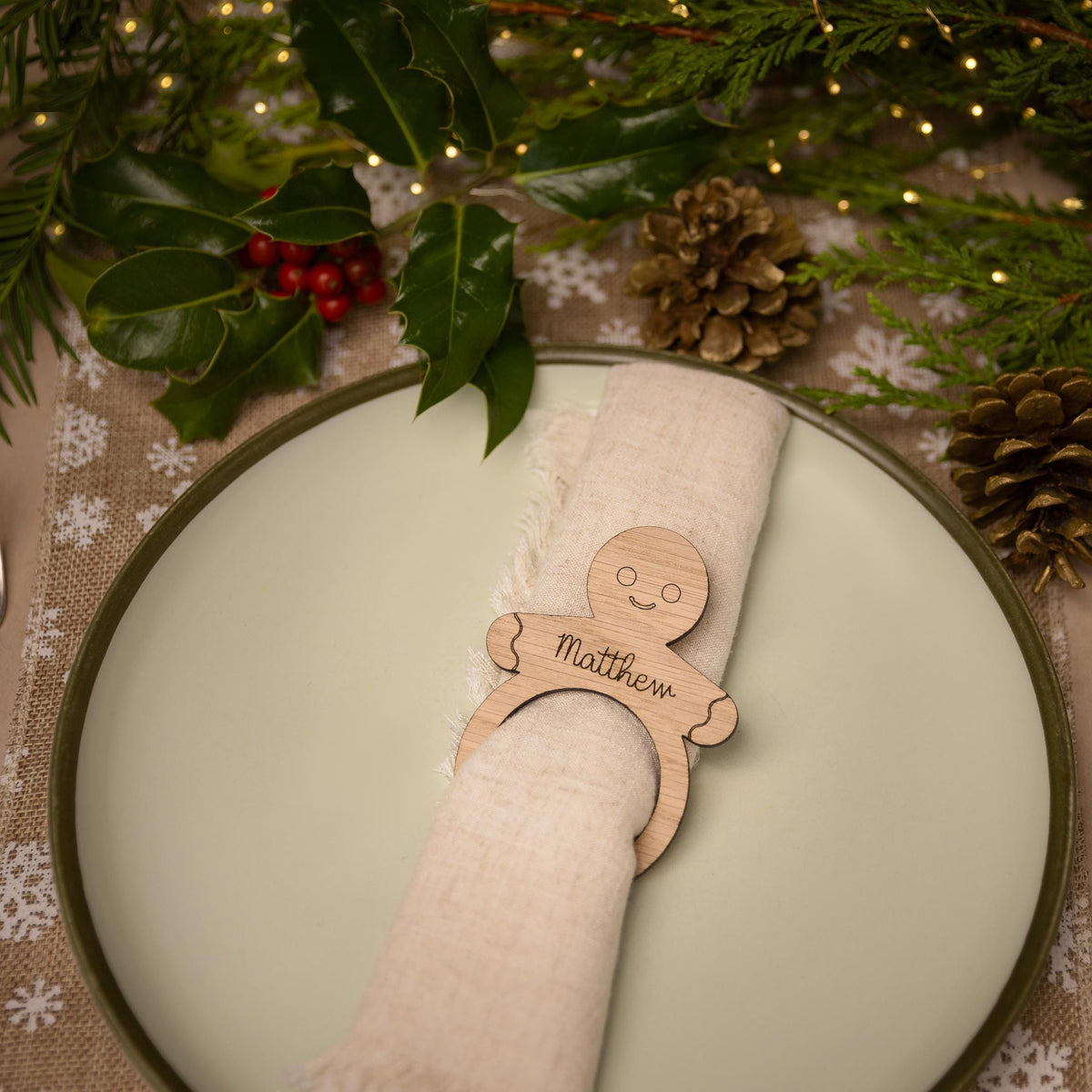 Wooden napkin ring with gingerbread man design.