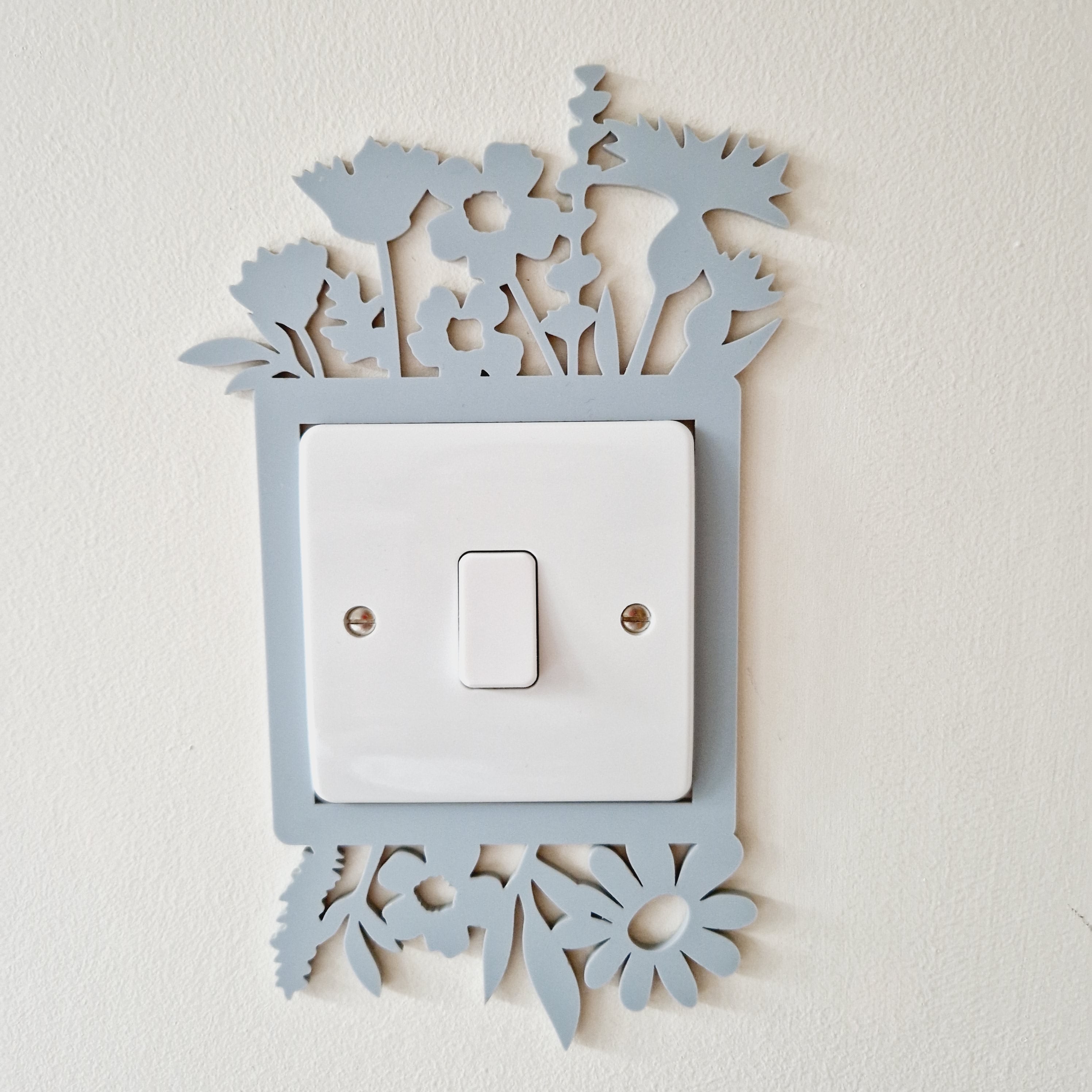 Decorative light switch cover with floral cutout design .