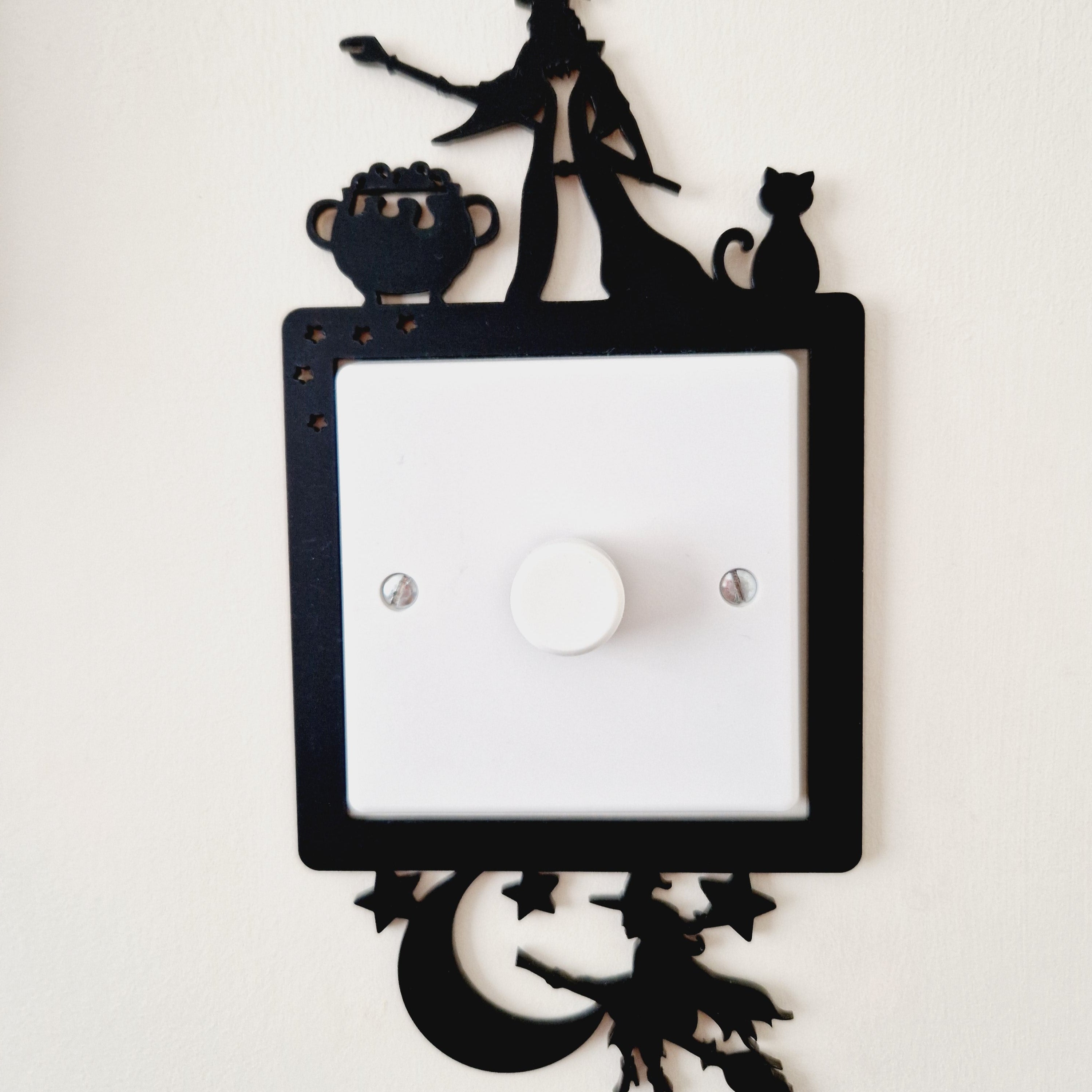 Decorative light frame with cut-out wizard and witch designs