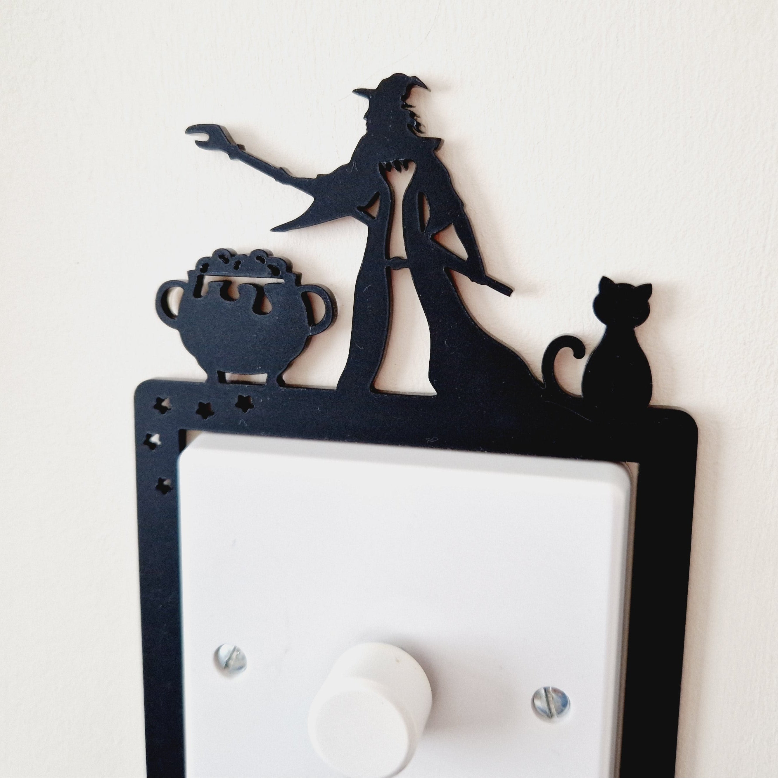 Decorative light switch cover with silhouette design of a witch and cat
