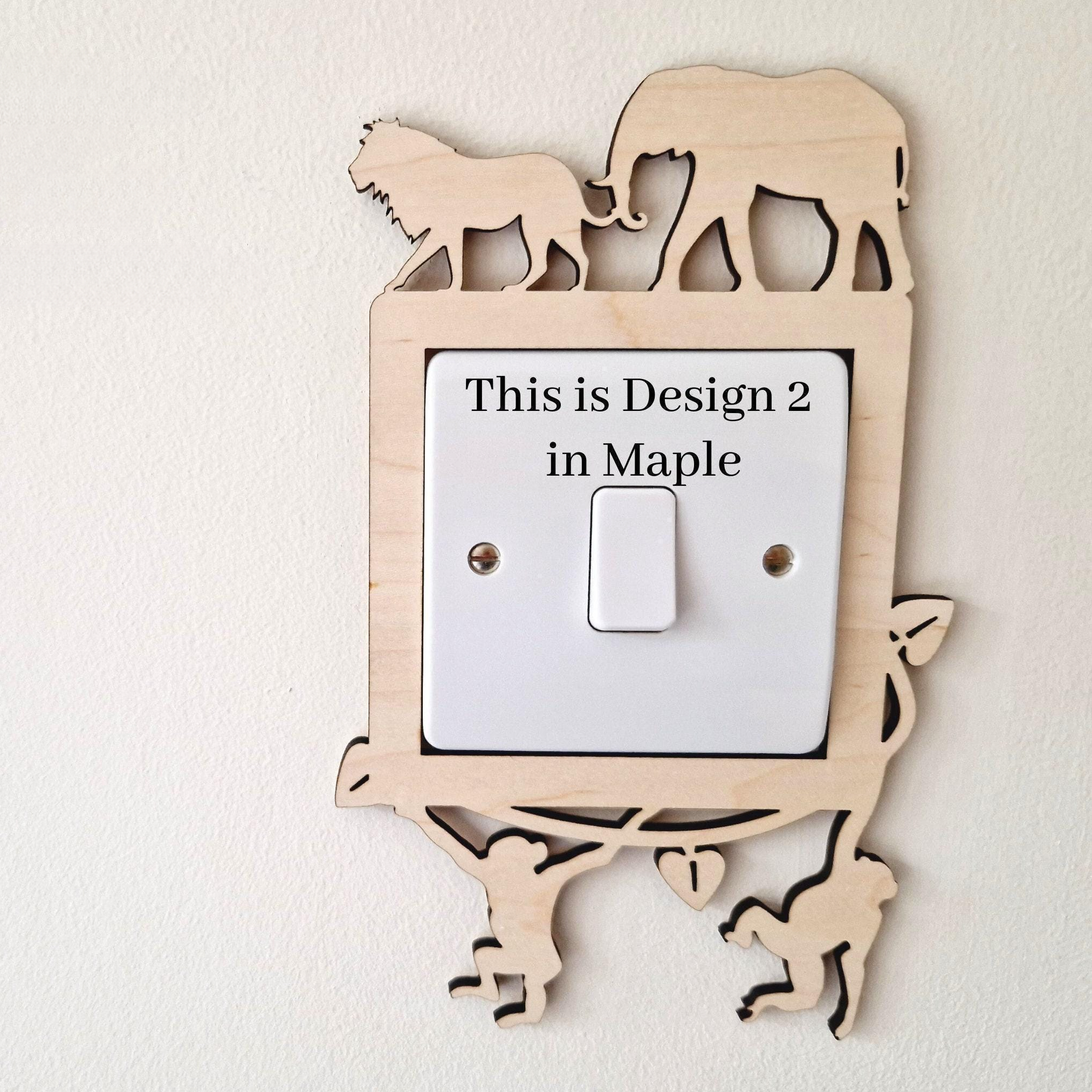 a wooden light switch with a design of an elephant and a lion on it, along with a description of the design.