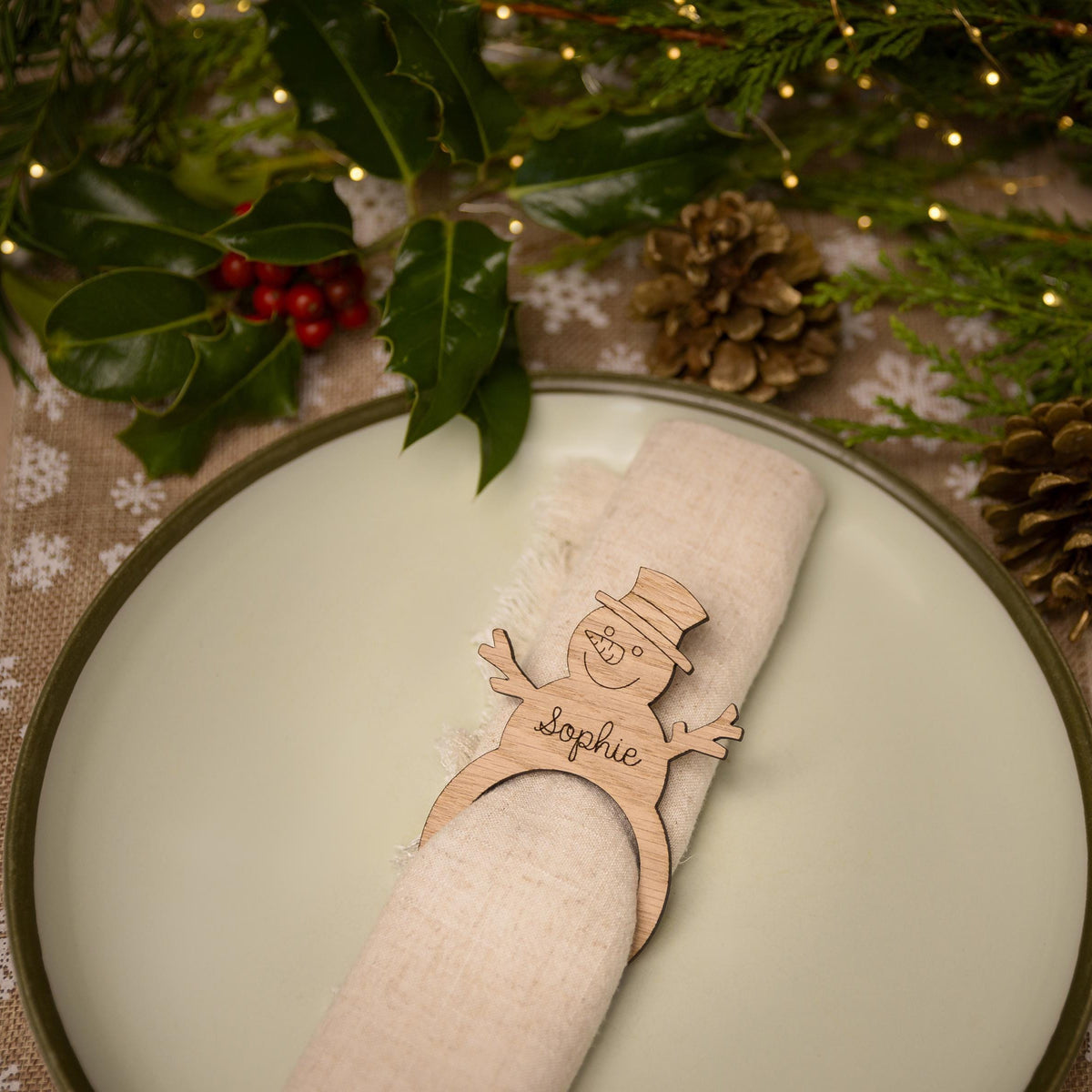 Wooden napkin ring with a snowman design.