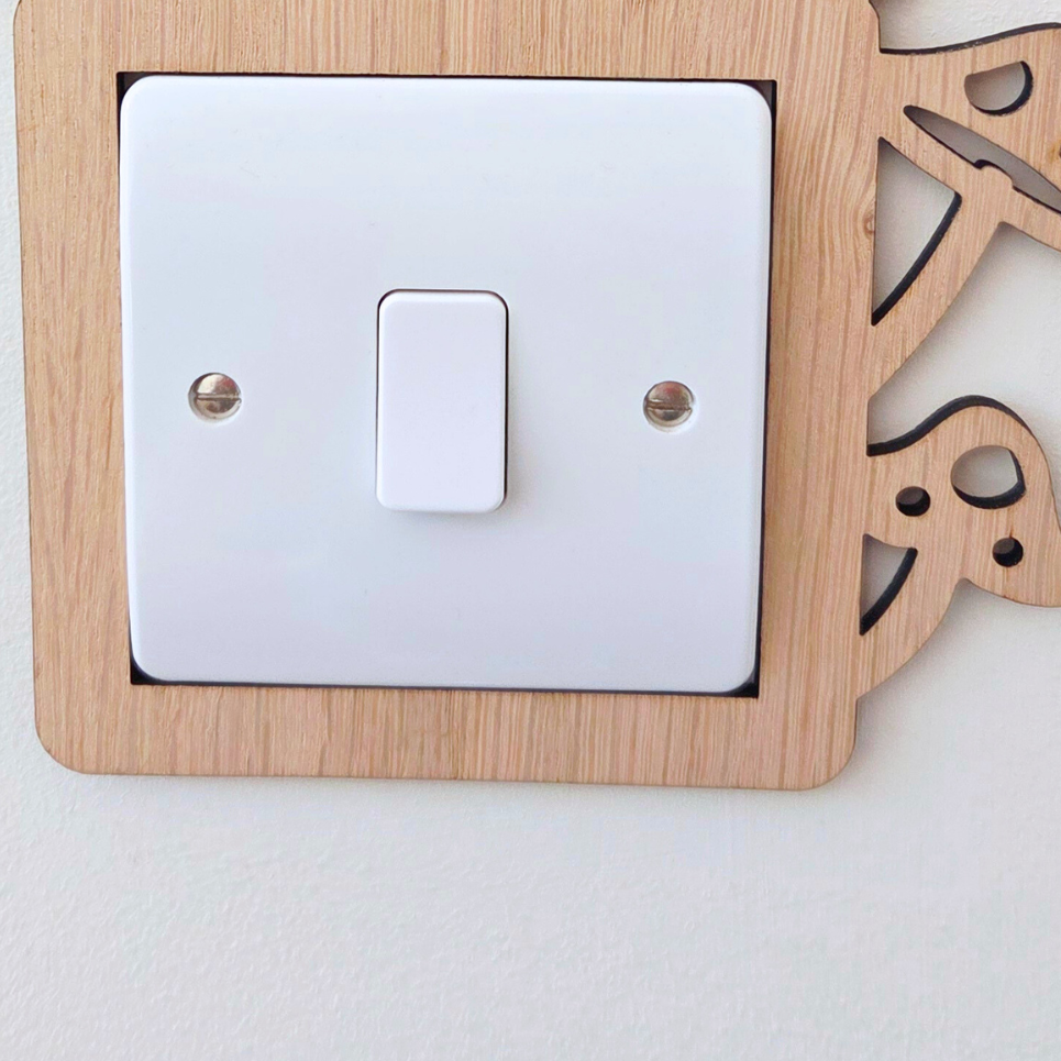 A wooden mushroom-shaped light switch on a wall.