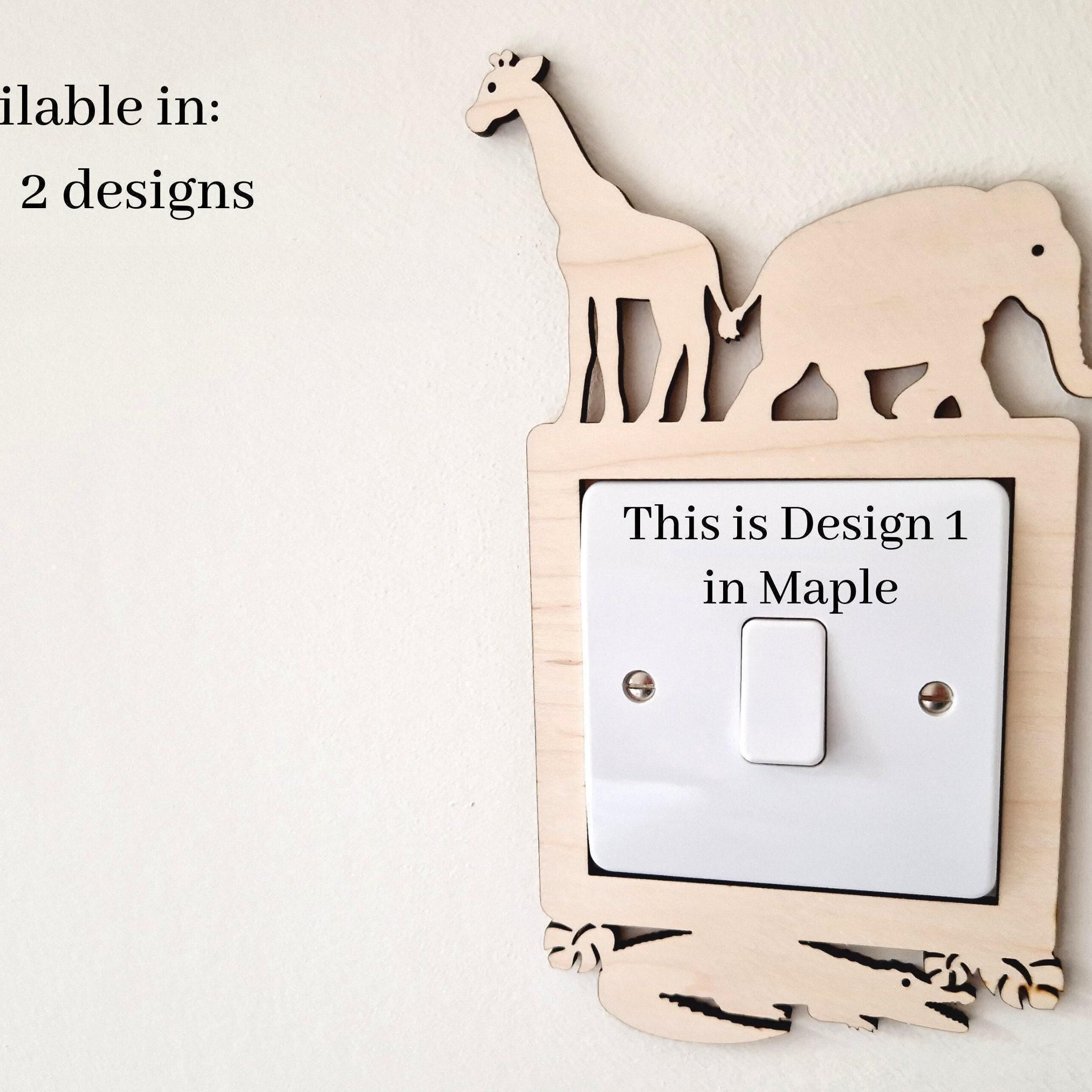 a wooden light switch with a giraffe and an elephant cutout on top, and the switch is labeled as "This is Design 1 in Maple".
