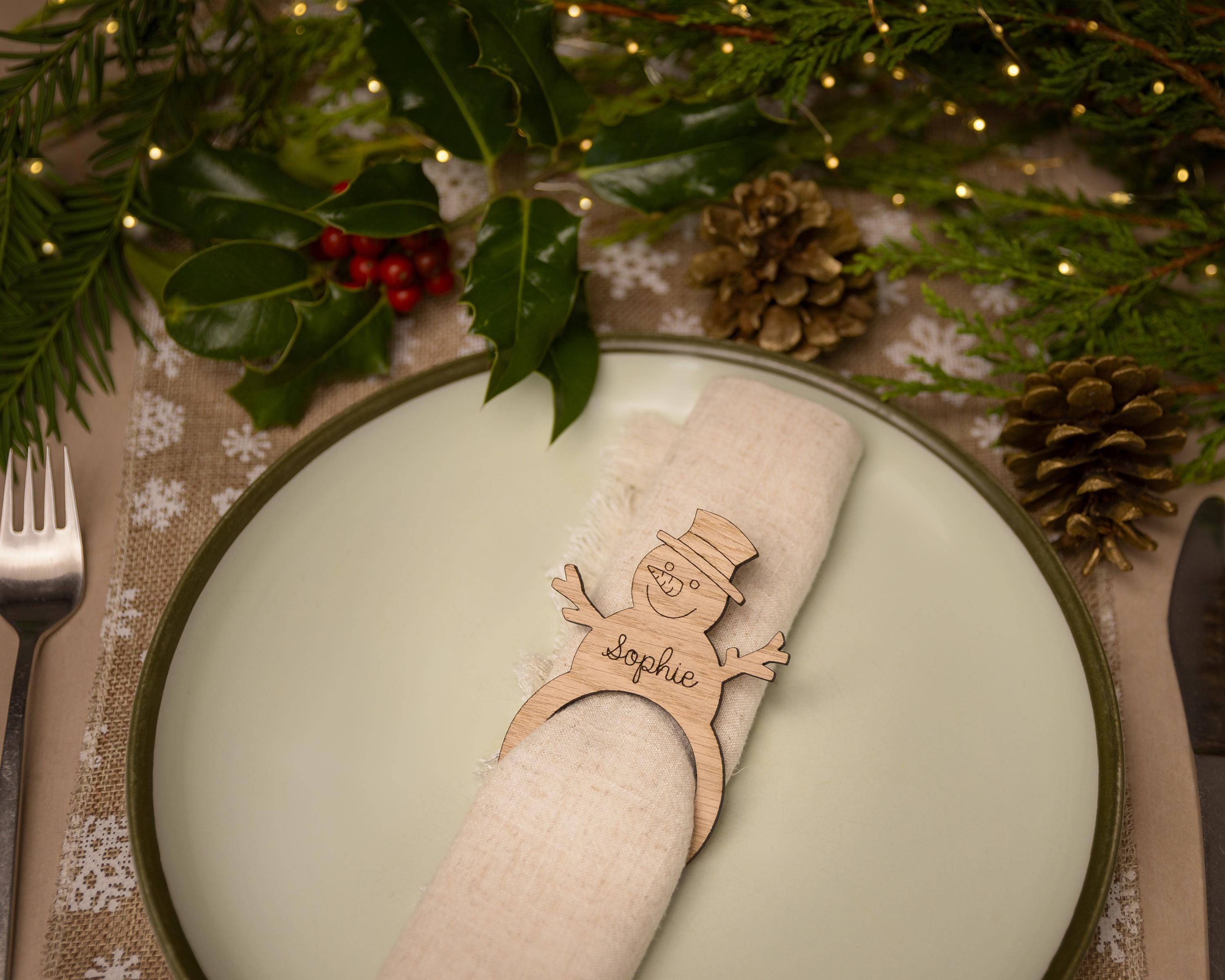 Wooden napkin ring with a snowman design.