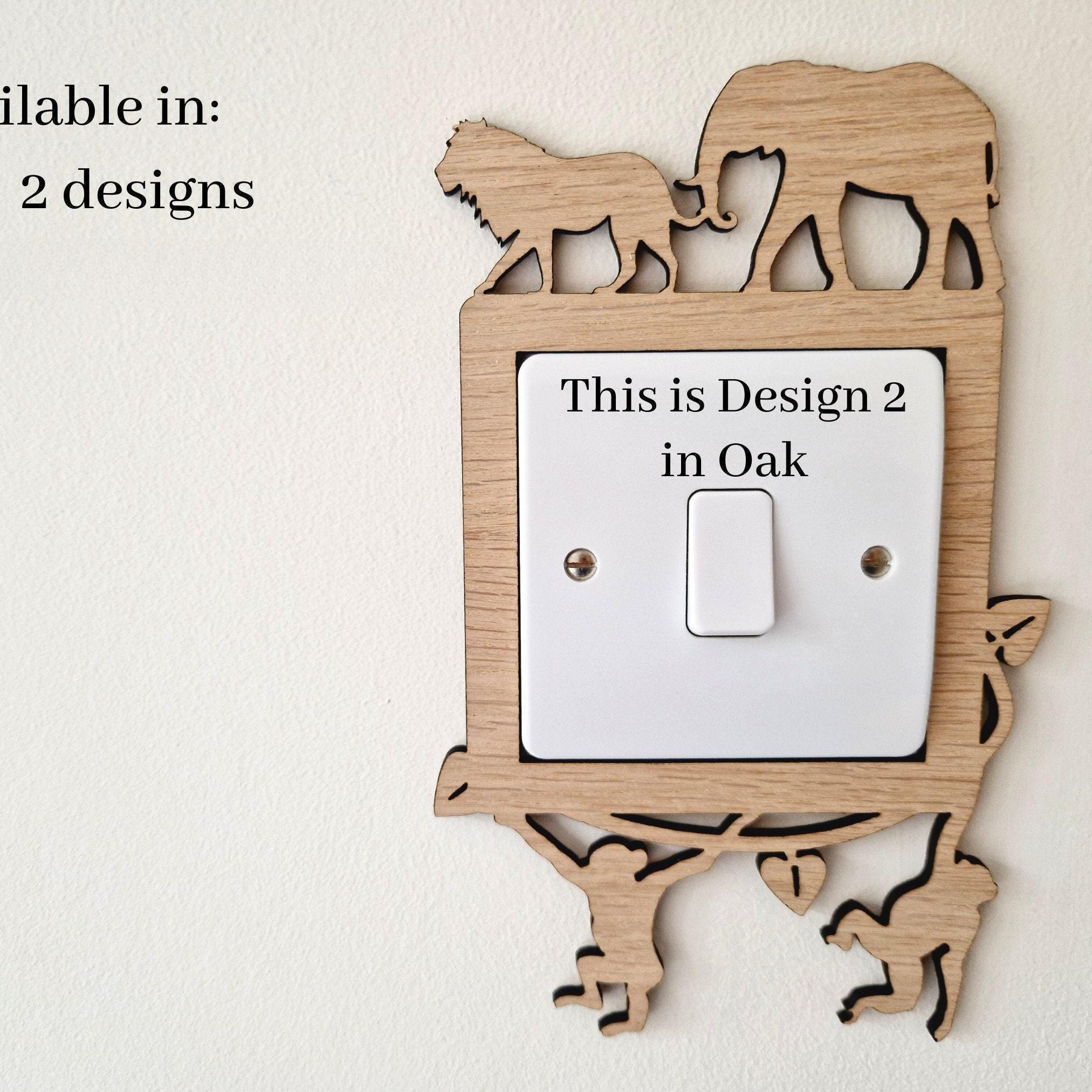 a wooden light switch with a design of an elephant and a lion on it, and there is text indicating that this is a design for a specific location.