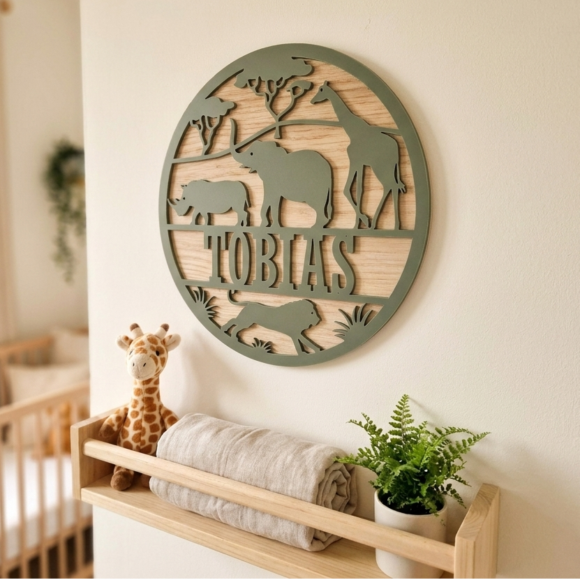 Wood and acrylic safari animal themed round name sign with animal cutouts and 'Tobias' name in a nursery setting.