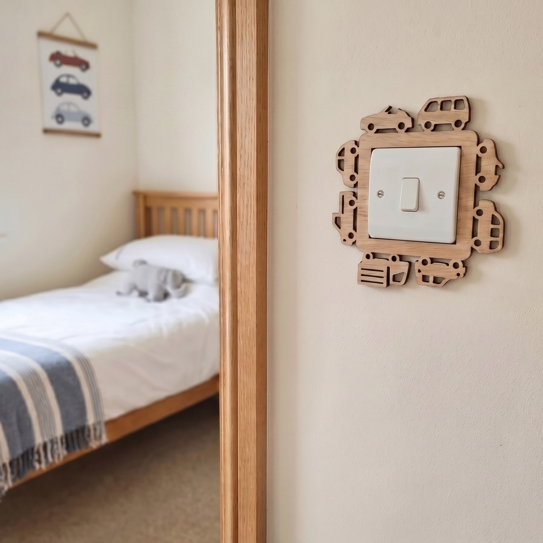 Kids bedroom with wooden bed and wooden decorative light switch cover with small car and trucks design.
