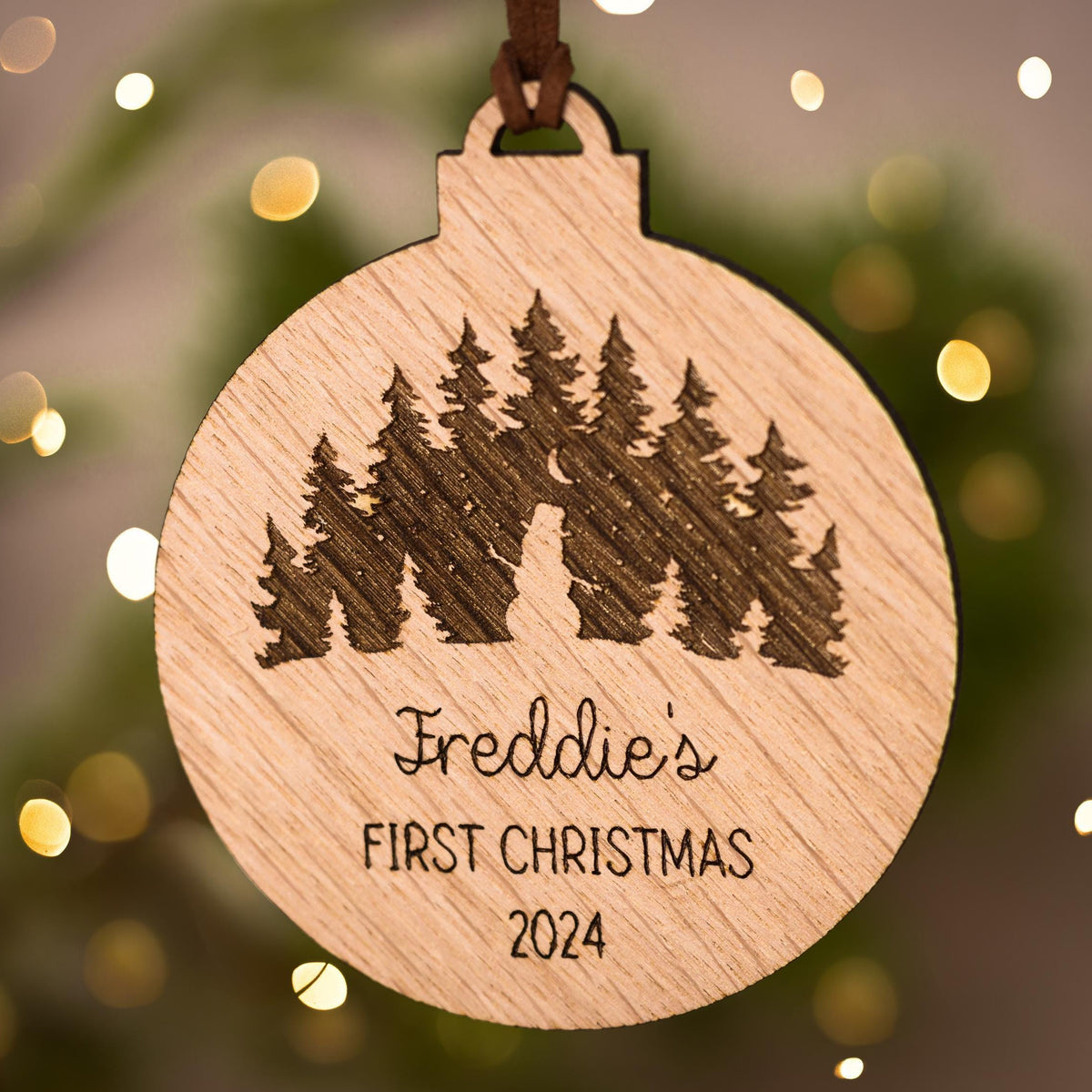 Wooden bauble with outdoor scene featuring a snowman