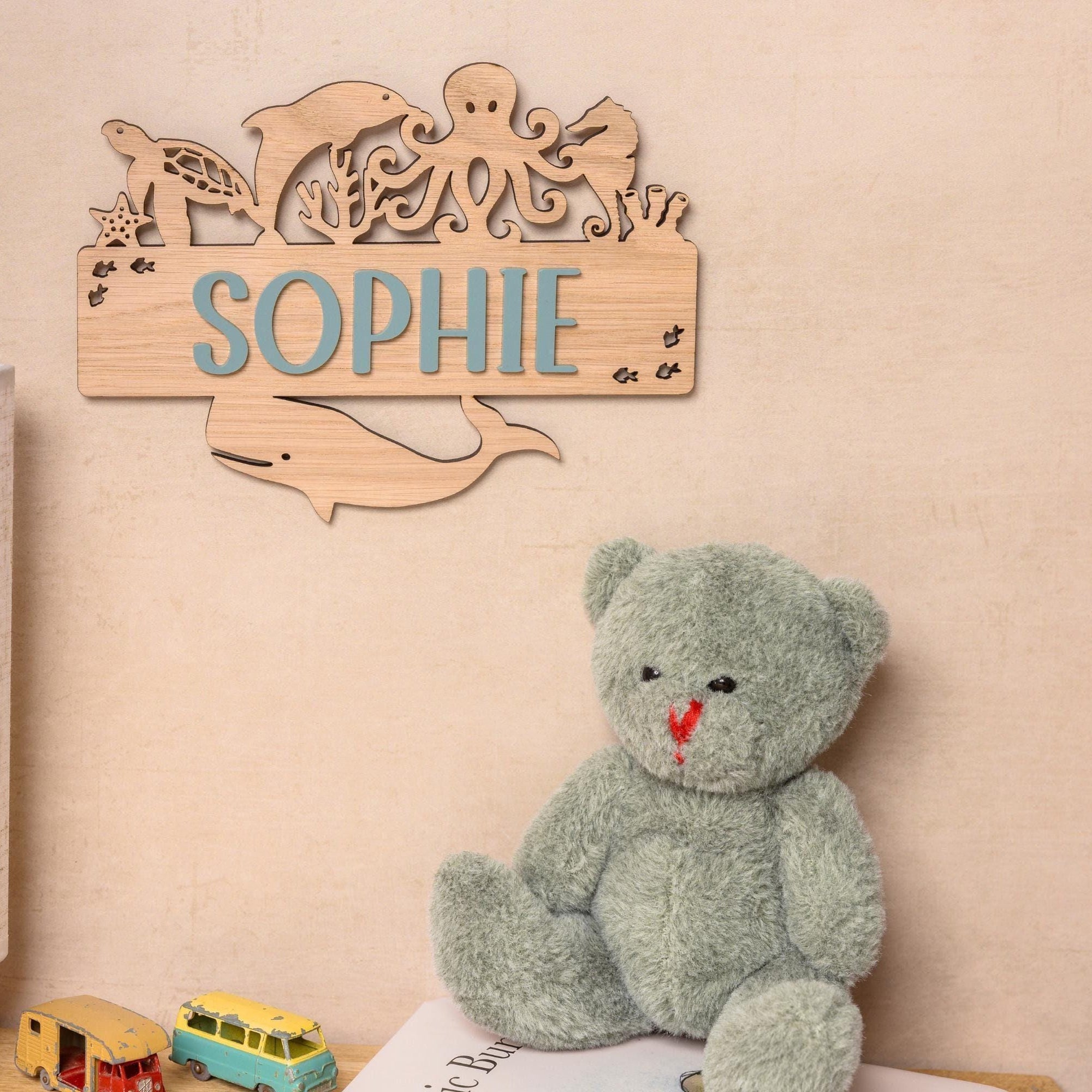 Wooden name sign with ocean creatures.