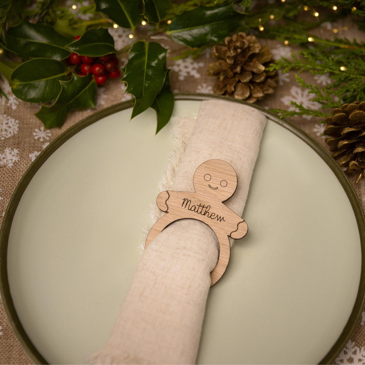 Wooden napkin ring with a gingerbread man design.