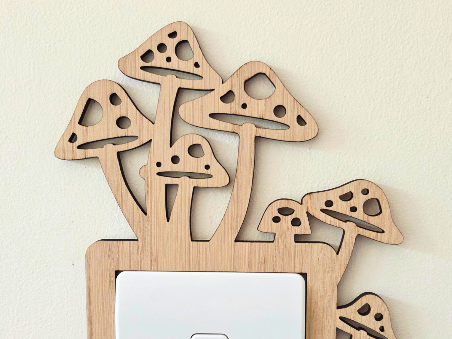 A wooden mushroom-shaped light switch cover is mounted on a wall.