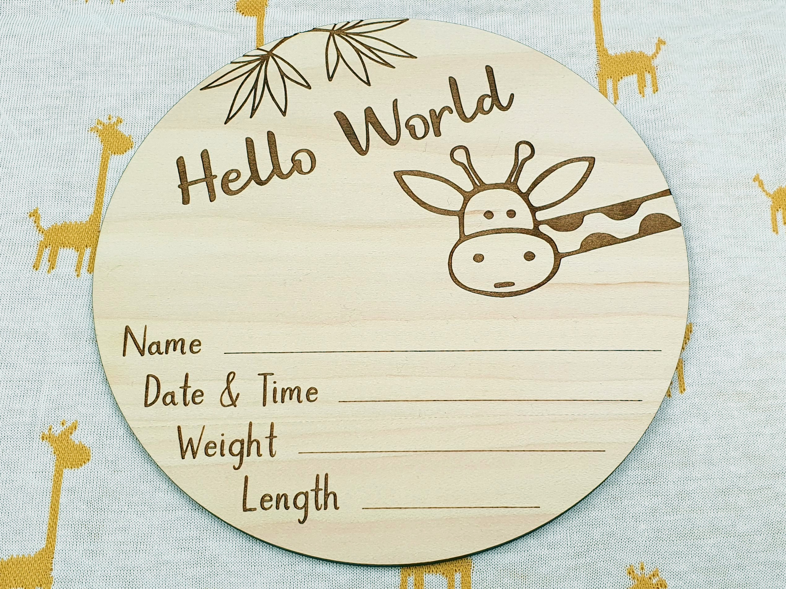 a wooden plaque with a giraffe design, placed on a surface with a repeating pattern of yellow giraffes.