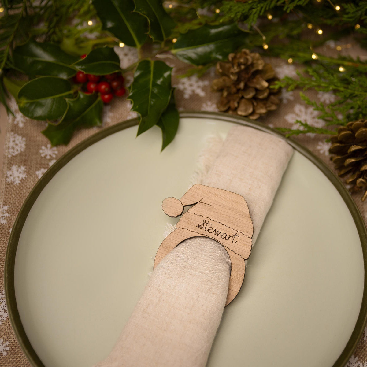 Wooden napkin ring with a christmas santa hat design.