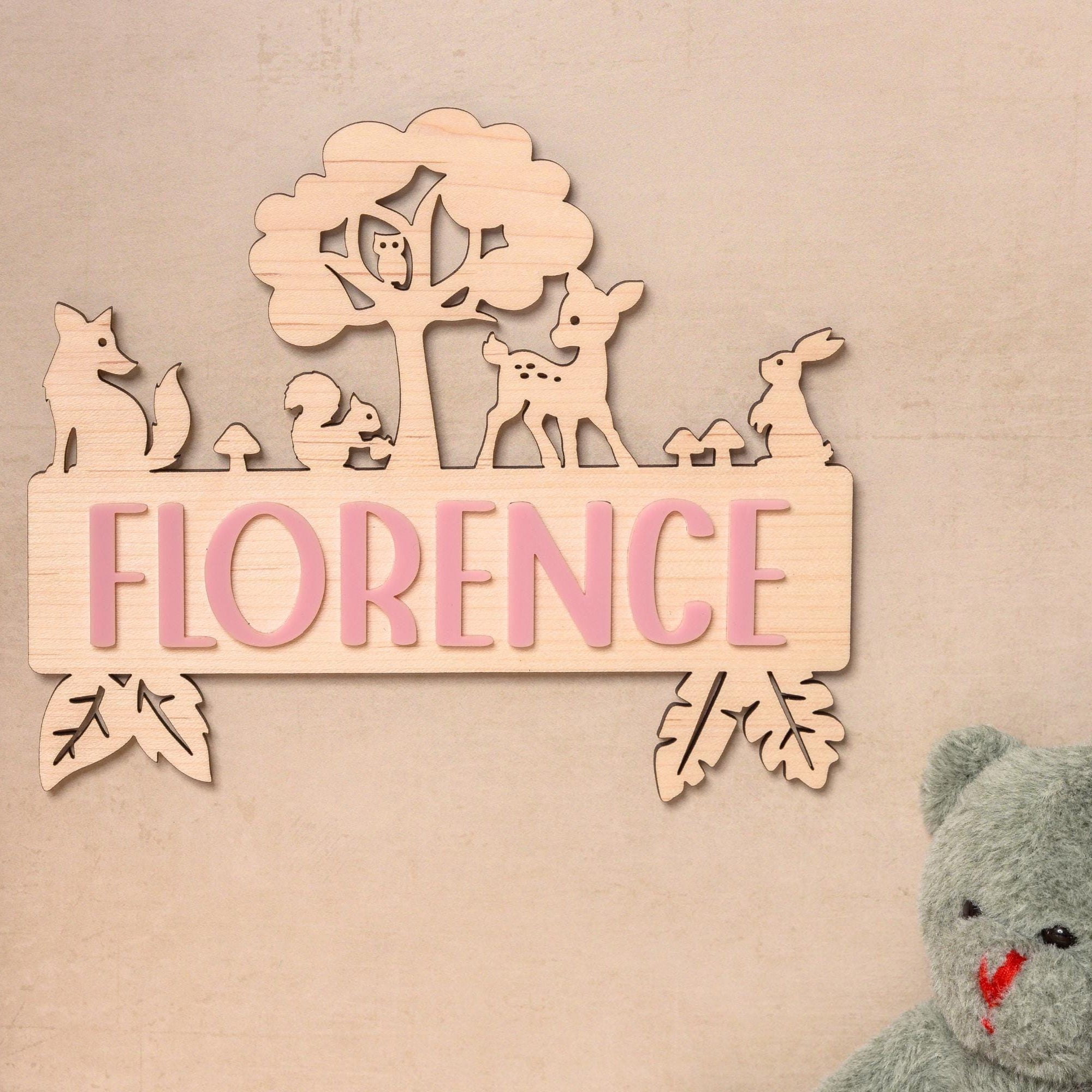 Wooden name sign with woodland animals.
