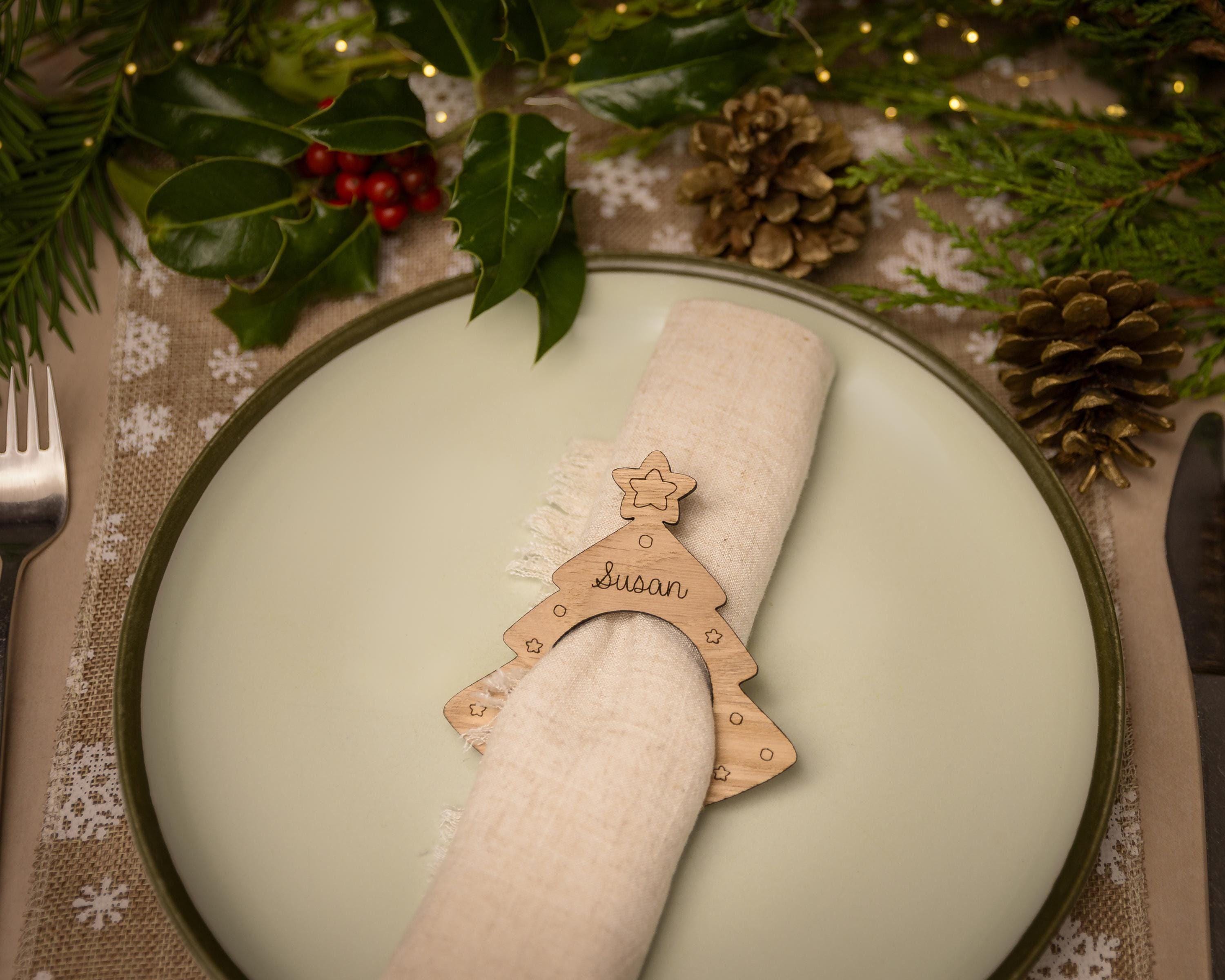 Wooden napkin ring with a christmas tree design.