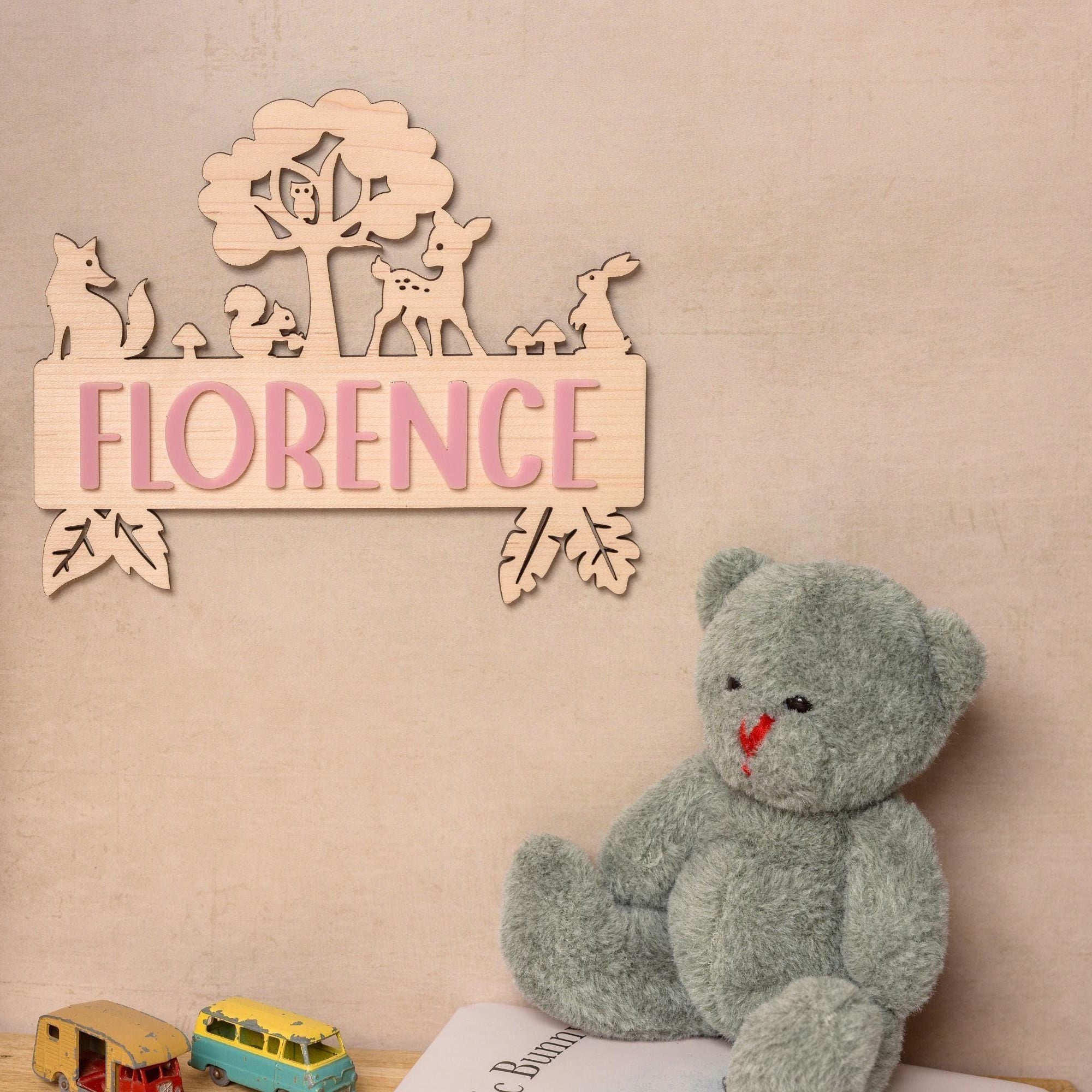 Wooden name sign with woodland animals.