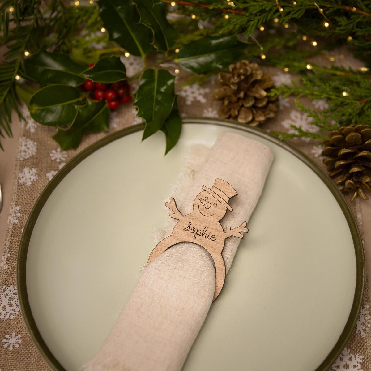 Wooden napkin ring with snowman design.