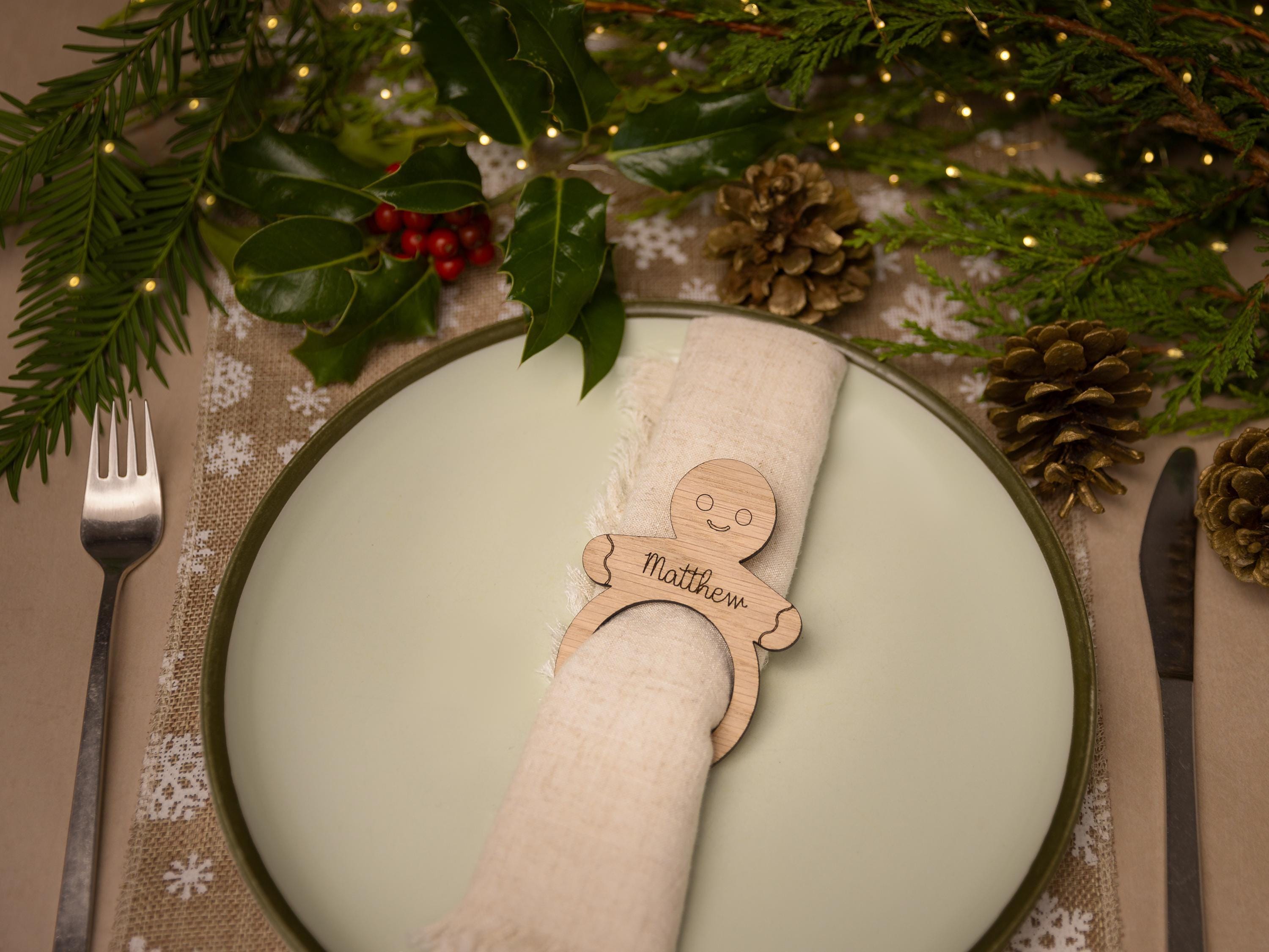Wooden napkin ring with gingerbread man design.