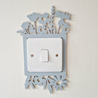 Decorative light switch cover with floral cutout design .