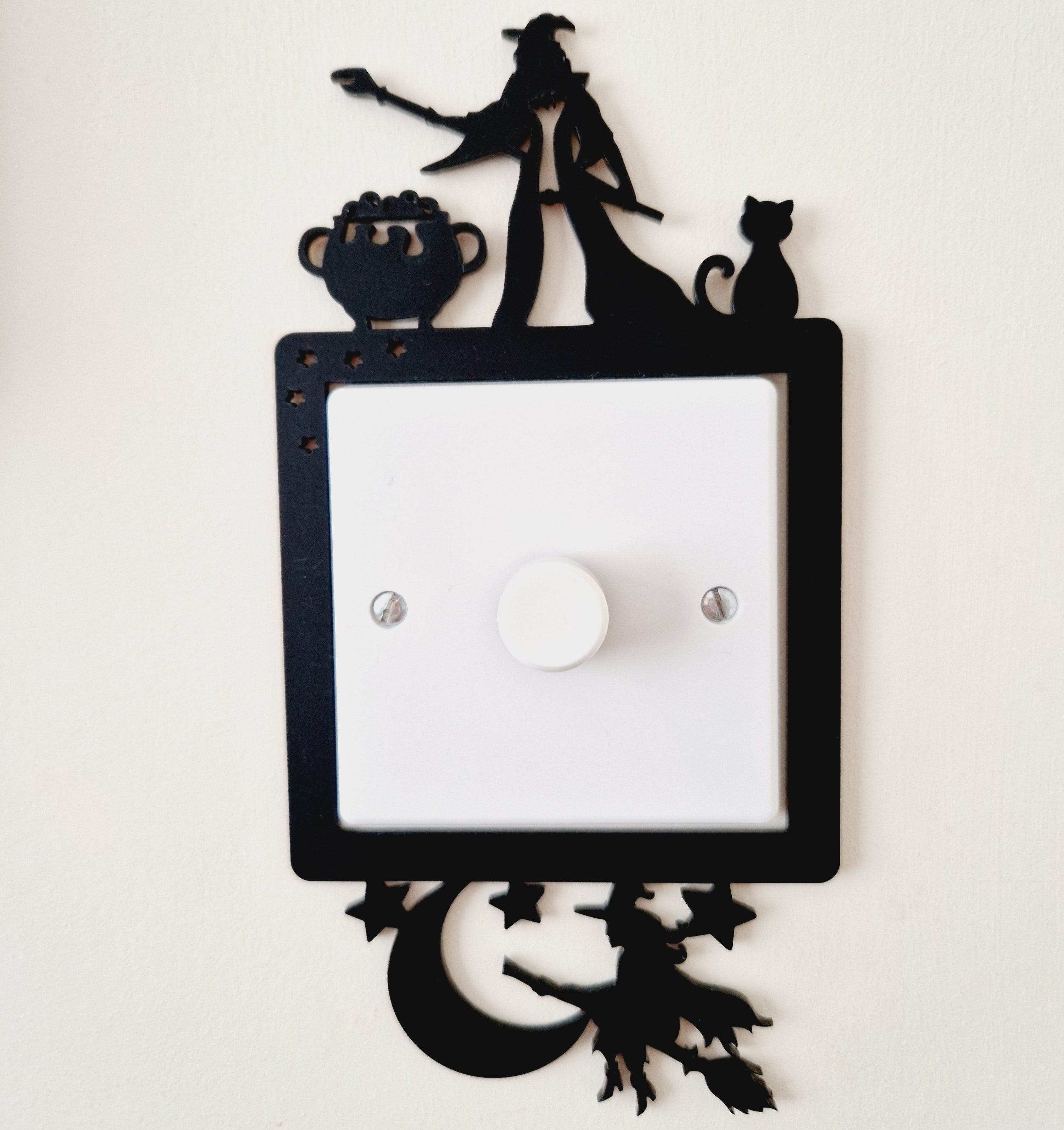 Decorative light frame with cut-out wizard and witch designs