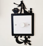 Decorative light frame with cut-out wizard and witch designs