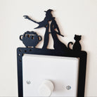 Decorative light switch cover with silhouette design of a witch and cat 