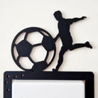 Decorative wall switch with a silhouette of a soccer player and ball on a white background