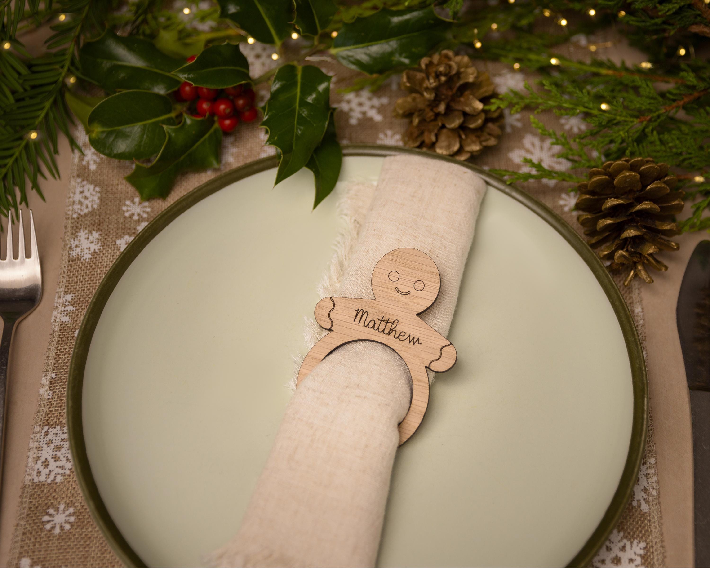 Wooden napkin ring with a gingerbread man design.