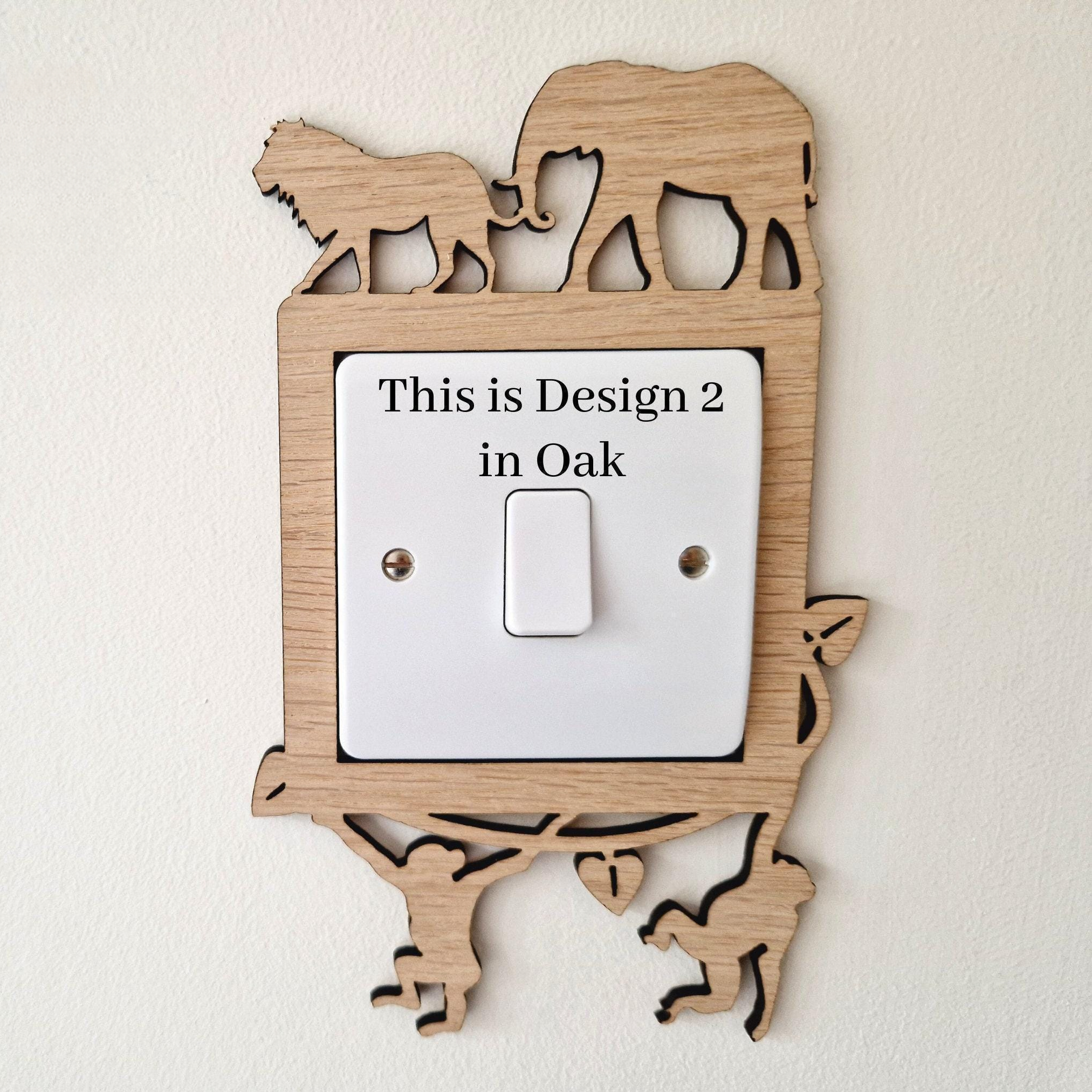 a wooden light switch with a design of an elephant and a lion on it, and there is text indicating that this is a design for a specific location.
