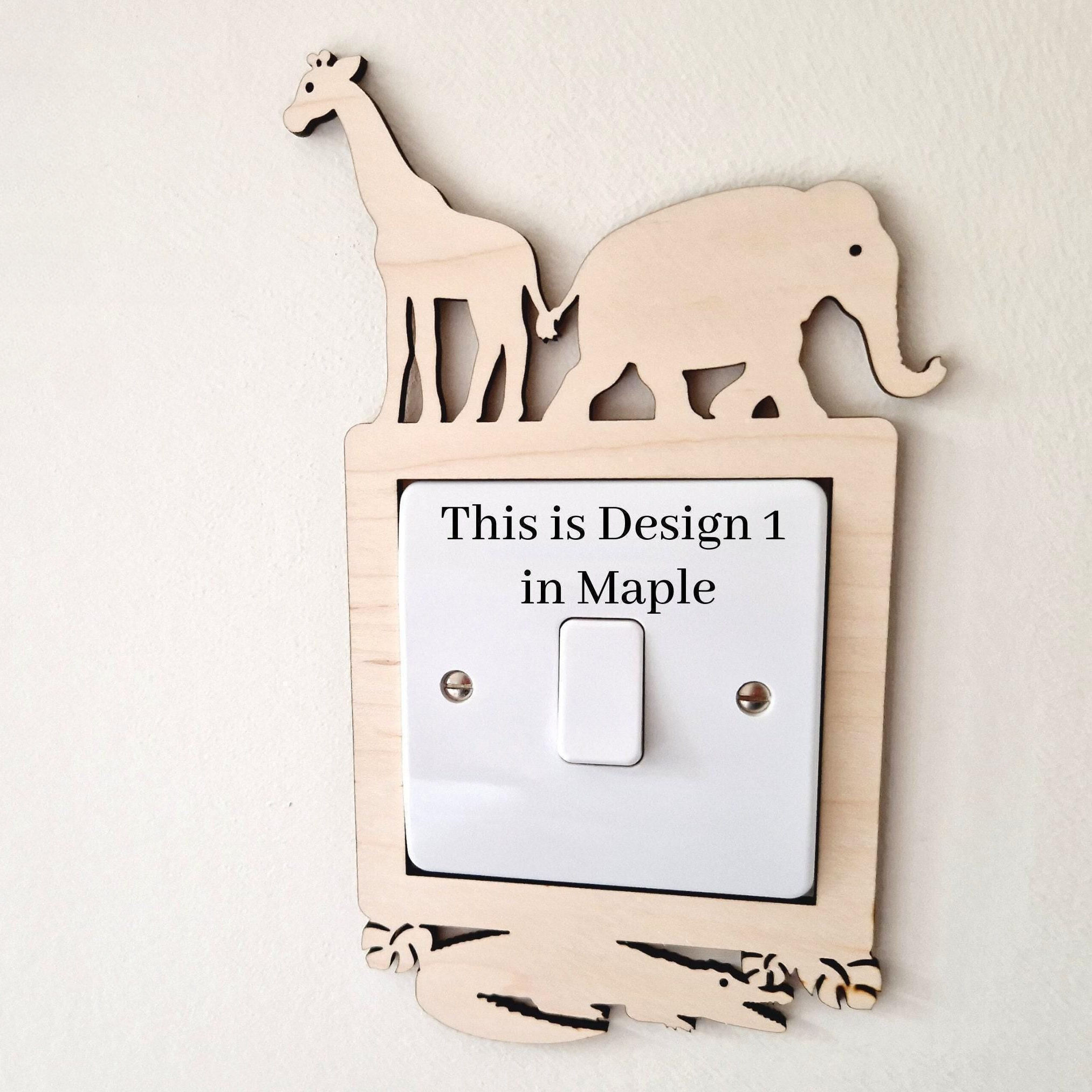 A wooden light switch with a giraffe and elephant silhouette on top, and the text "This is Design 1 in Maple" on the switch.