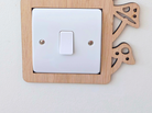 A wooden mushroom-shaped light switch on a wall.