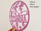 a pink, circular object with the name 'CASSANDRA' written on it.