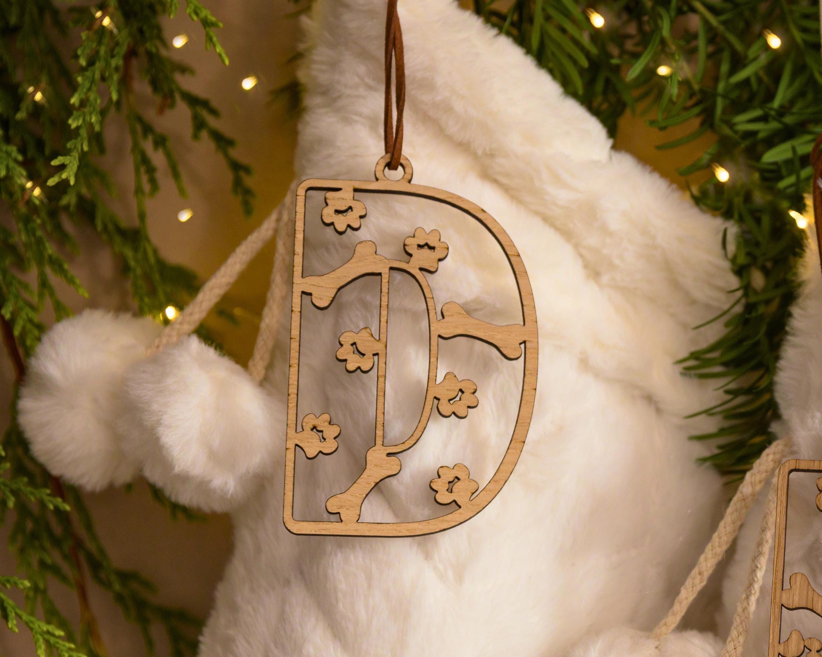Wooden stocking tag with paws and bone design.