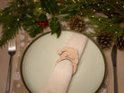 Wooden napkin ring with santa hat design.