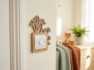 Decorative wooden light switch plate with mushroom design on a lightly colored wall.