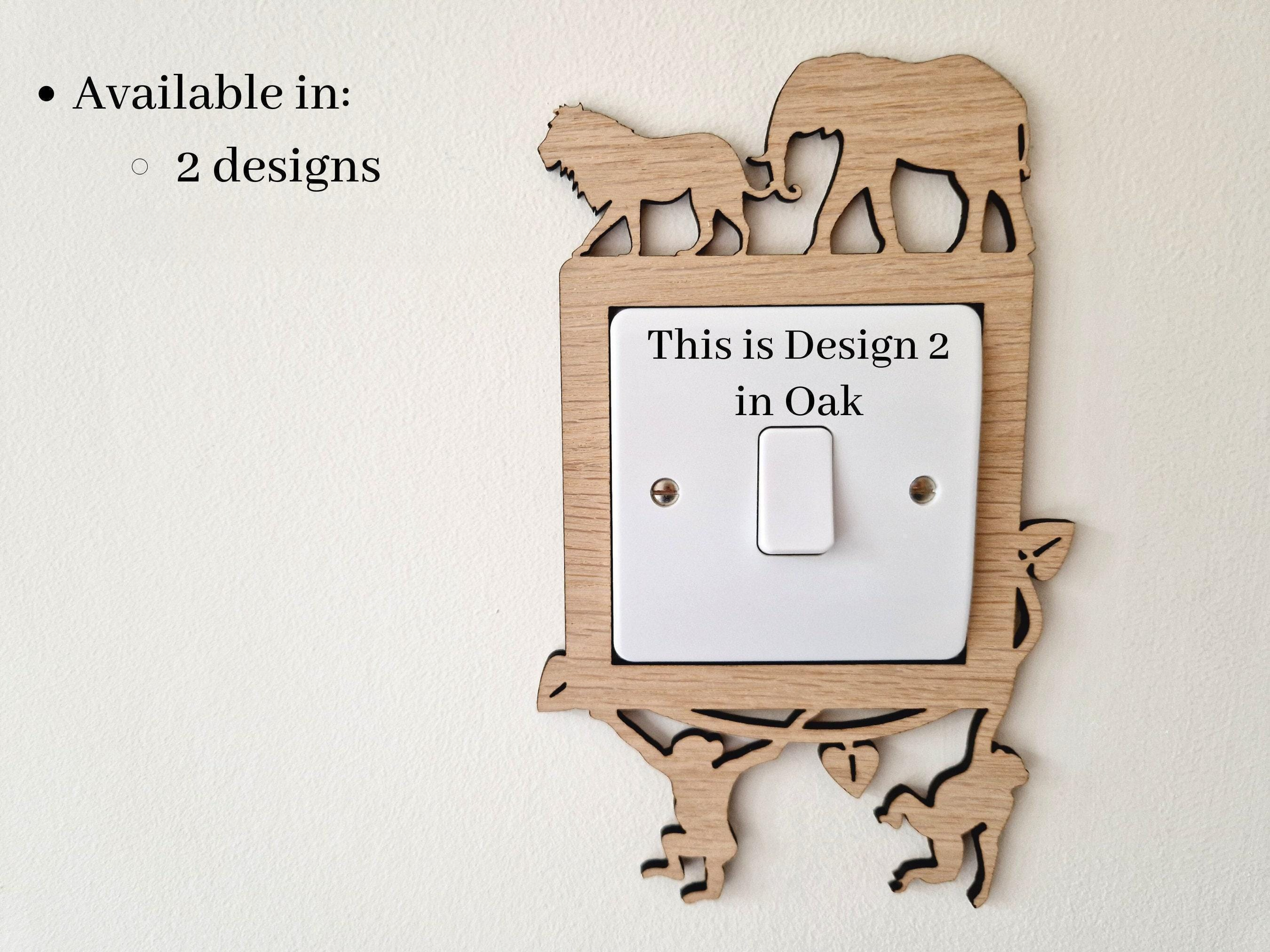 a wooden light switch with a design of an elephant and a lion on it, and there is text indicating that this is a design for a specific location.
