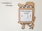 a wooden light switch with a design of an elephant and a lion on it, and there is text indicating that this is a design for a specific location.