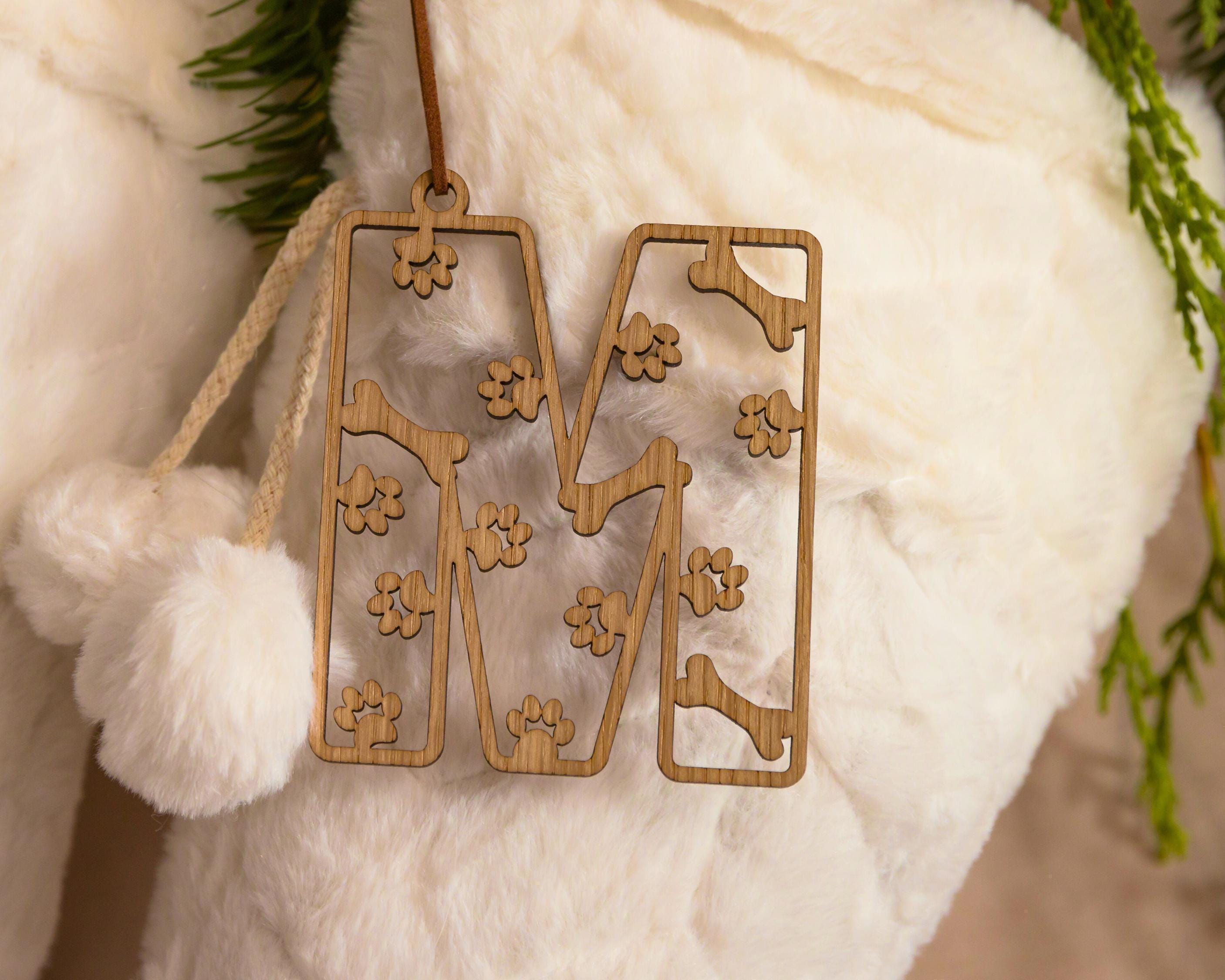 Wooden stocking tag with paws and bone design.