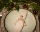 Wooden napkin ring with a christmas tree design.