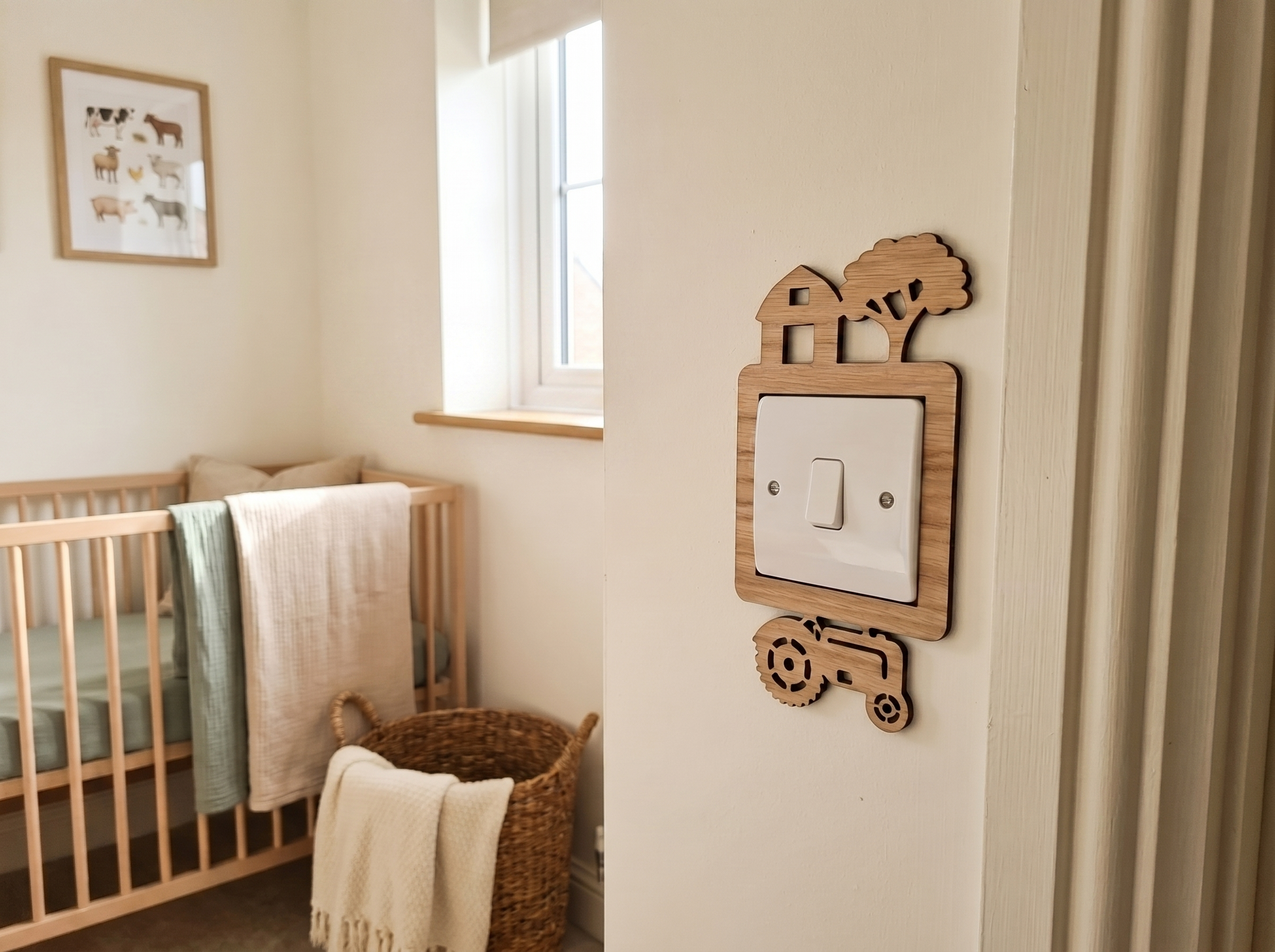 Nursery room with wooden crib, basket, and wooden decorative light switch cover with a barn, tree and tractor design.