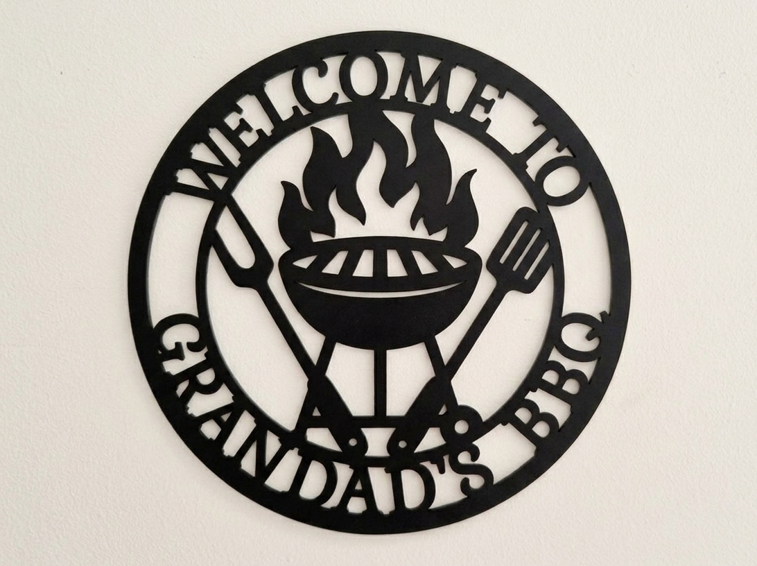 Decorative acrylic sign with 'Welcome to Grandad's BBQ' text and grill design on a beige background