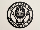 Decorative acrylic sign with 'Welcome to Grandad's BBQ' text and grill design on a beige background