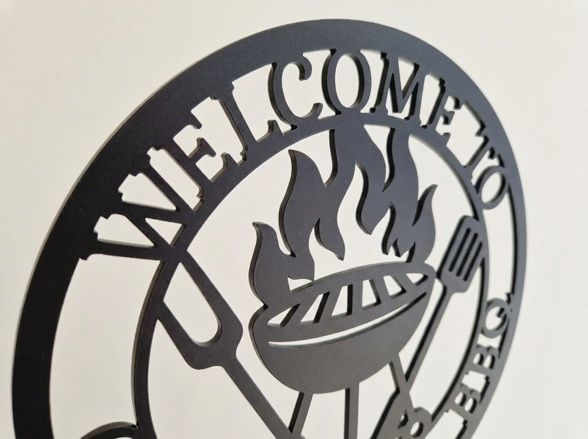 Close up of decorative acrylic sign with 'Welcome to Grandad's BBQ' text and grill icon on a beige background