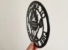 Side profile of decorative acrylic round sign with 'Welcome to the Grandad's BBQ' text and grill icon on a plain background