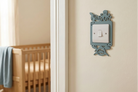 Ocean themed light switch cover with a turtle, octopus, shark and fish design in a nursery setting.