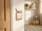 Wooden light switch cover with jungle  animal design in a child's room safari themed bedroom. 