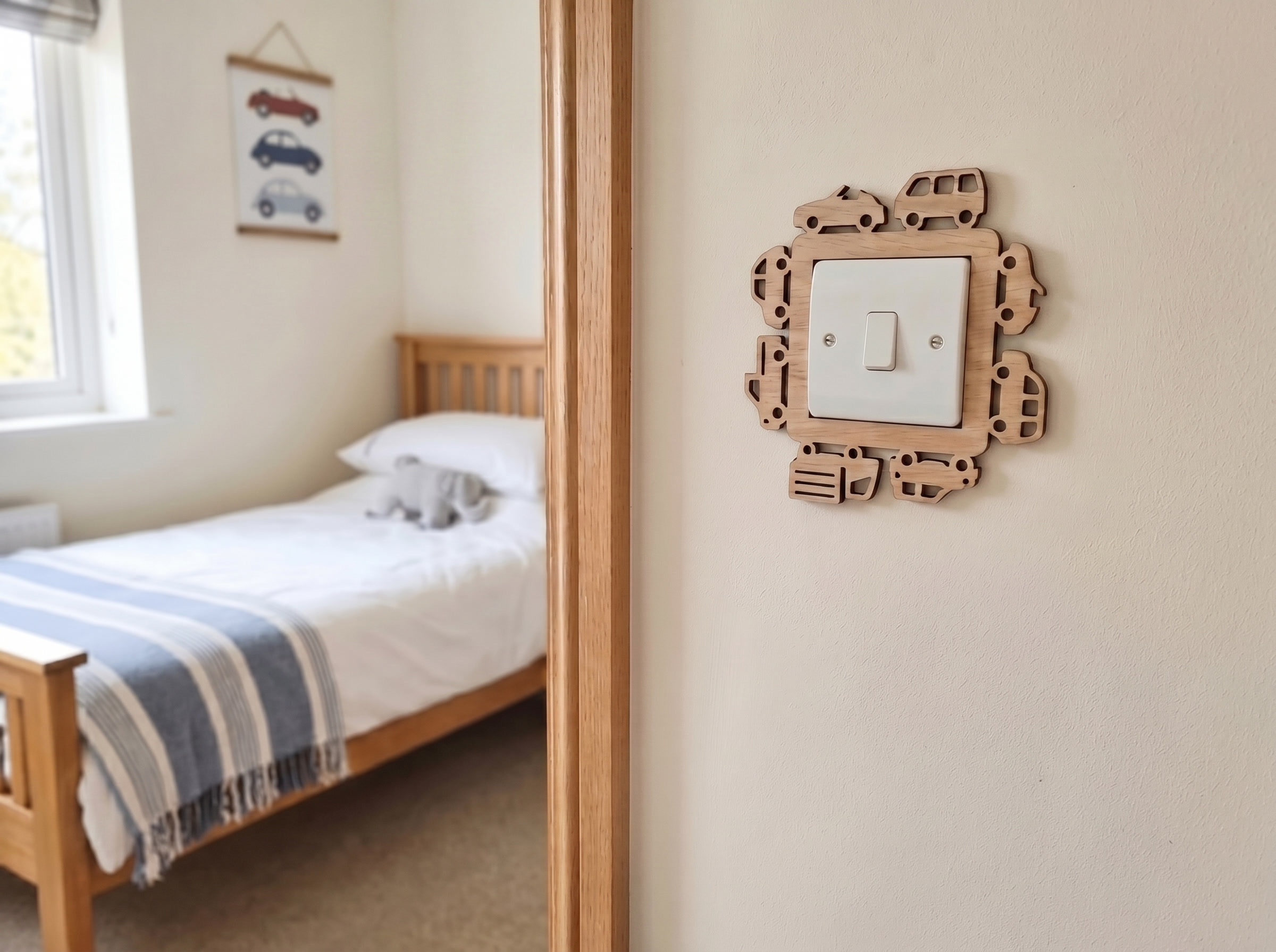 Kids bedroom with wooden bed and wooden decorative light switch cover with small car and trucks design.