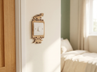 Wooden decorative light switch cover with a T-Rex and Stegosaurus design on a wall next to a bed with sunlight streaming through curtains.