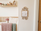 Decorative wooden light switch cover with woodland fox, deer and owl design in a nursery setting.
